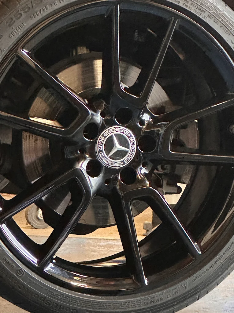 Gloss black alloy wheel after professional refurbishment in Burton-on-Trent