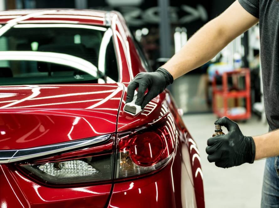 Technician applying ceramic coating to vehicle