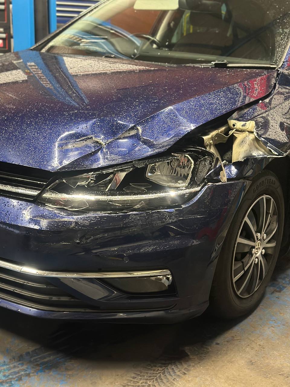 Front driver-side bumper, headlight, hood, and wing showing damage before repair in Burton-on-Trent