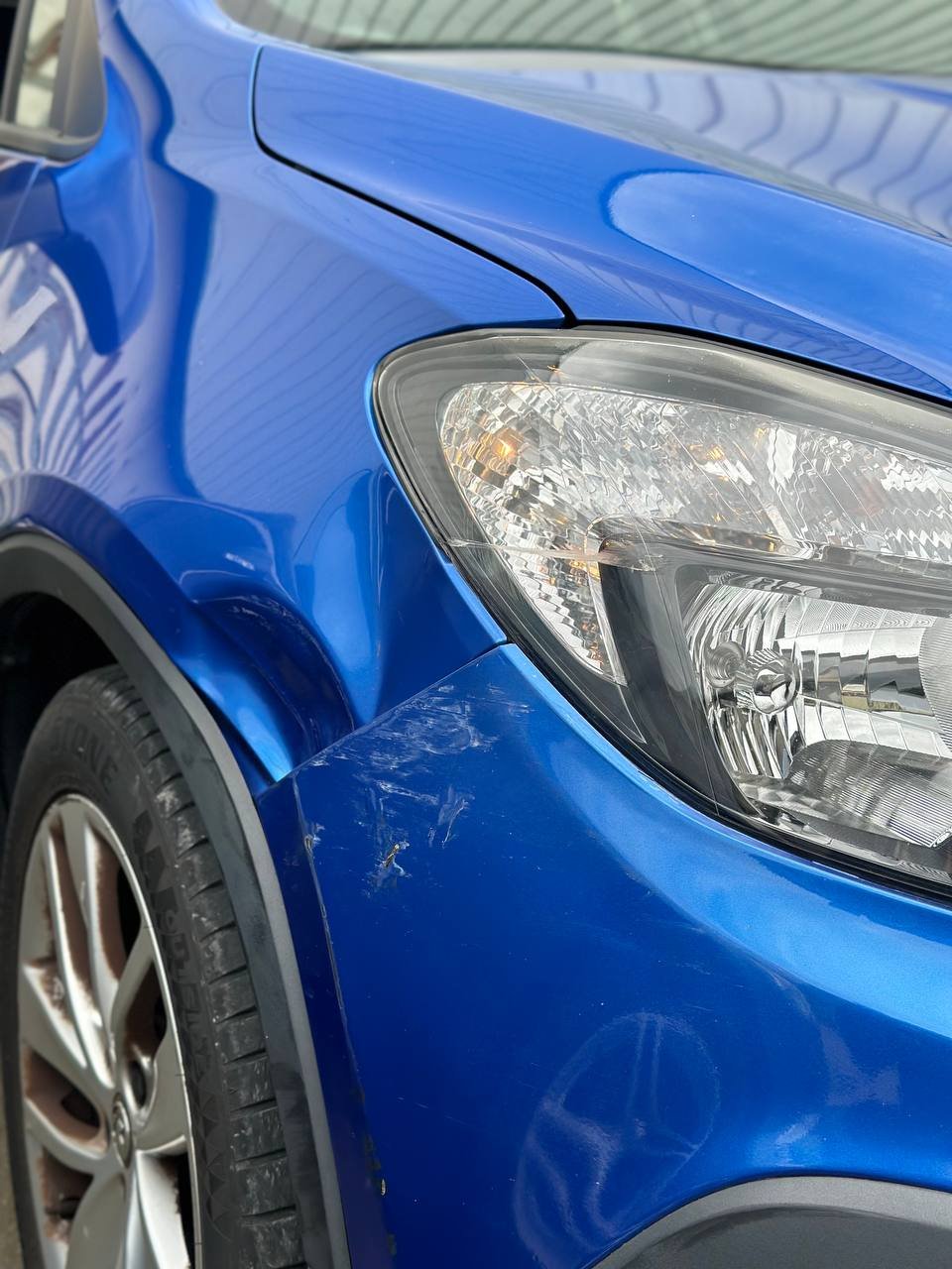 Dent on front driver-side wing before repair at Dent Dynamics Burton-on-Trent