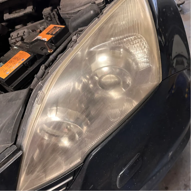Cloudy oxidised headlight before headlight restoration Burton-on-Trent