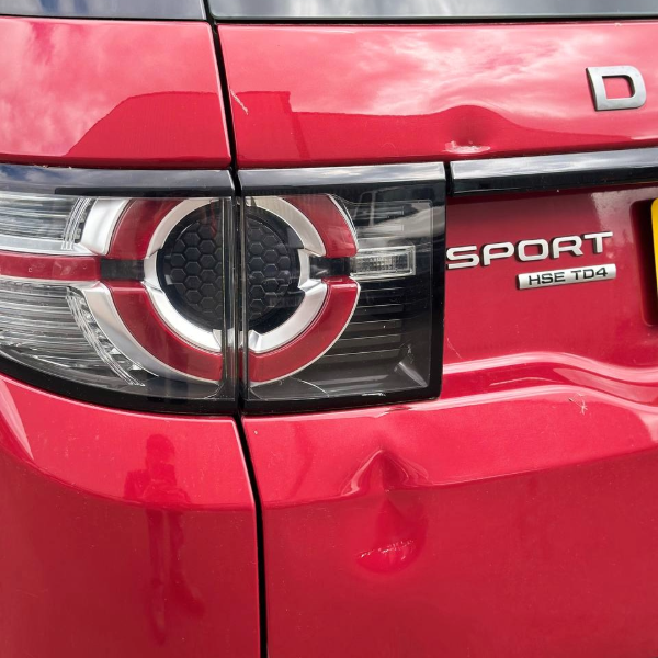 Car body repair Burton-on-Trent – rear panel dent before repair on red Range Rover